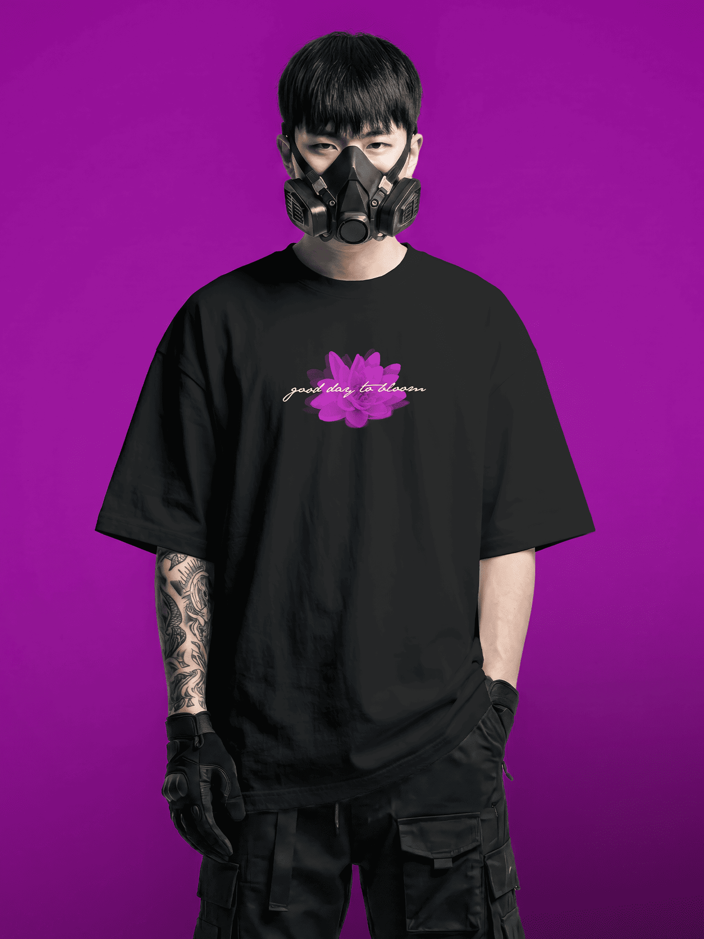 Person wearing a black t-shirt with a purple flower design on a purple background