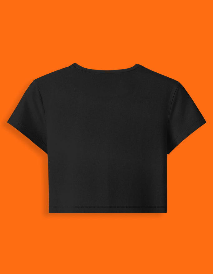 Black crop top on an orange background
