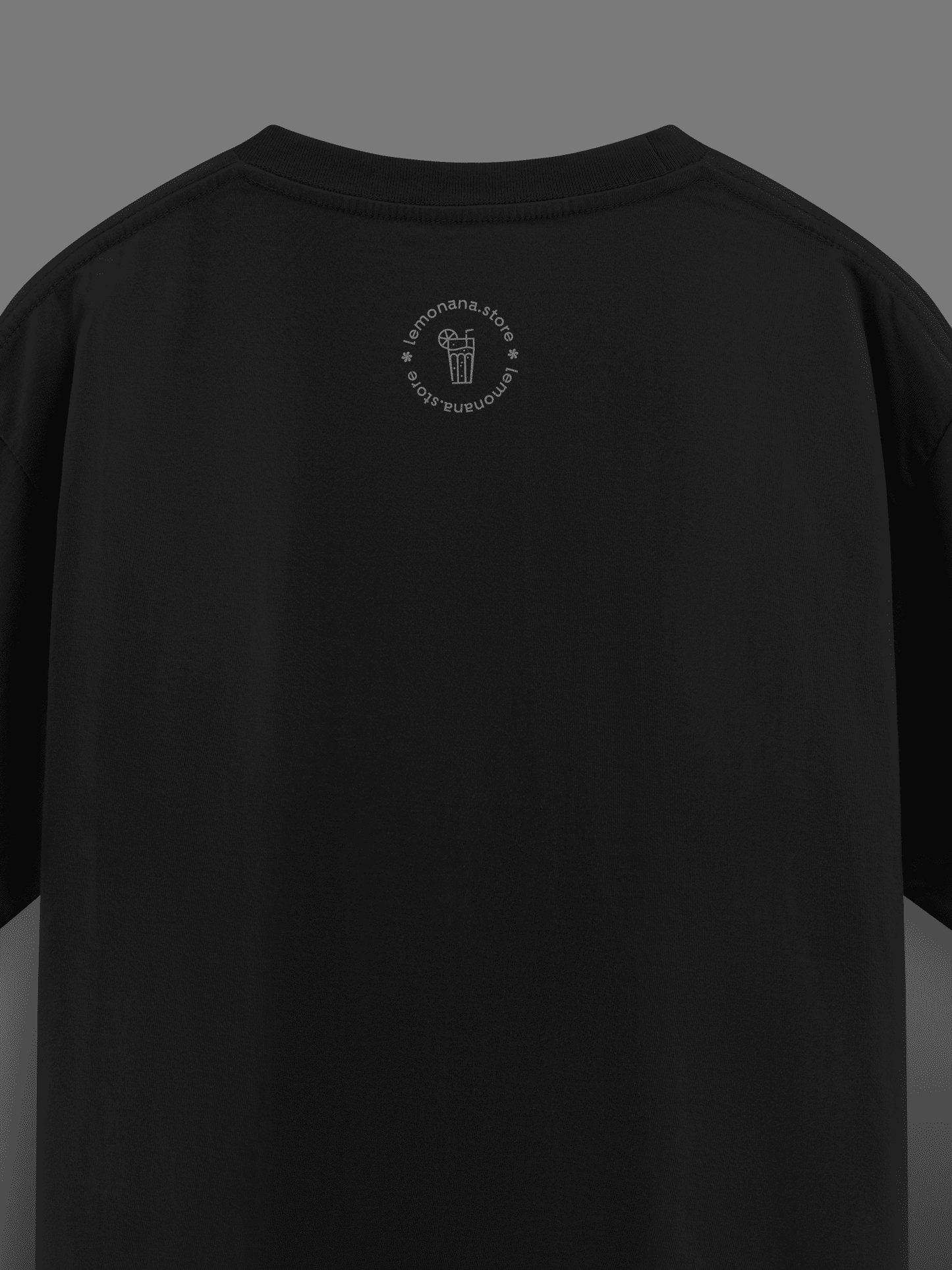 Black t-shirt with a small logo on the chest against a dark background