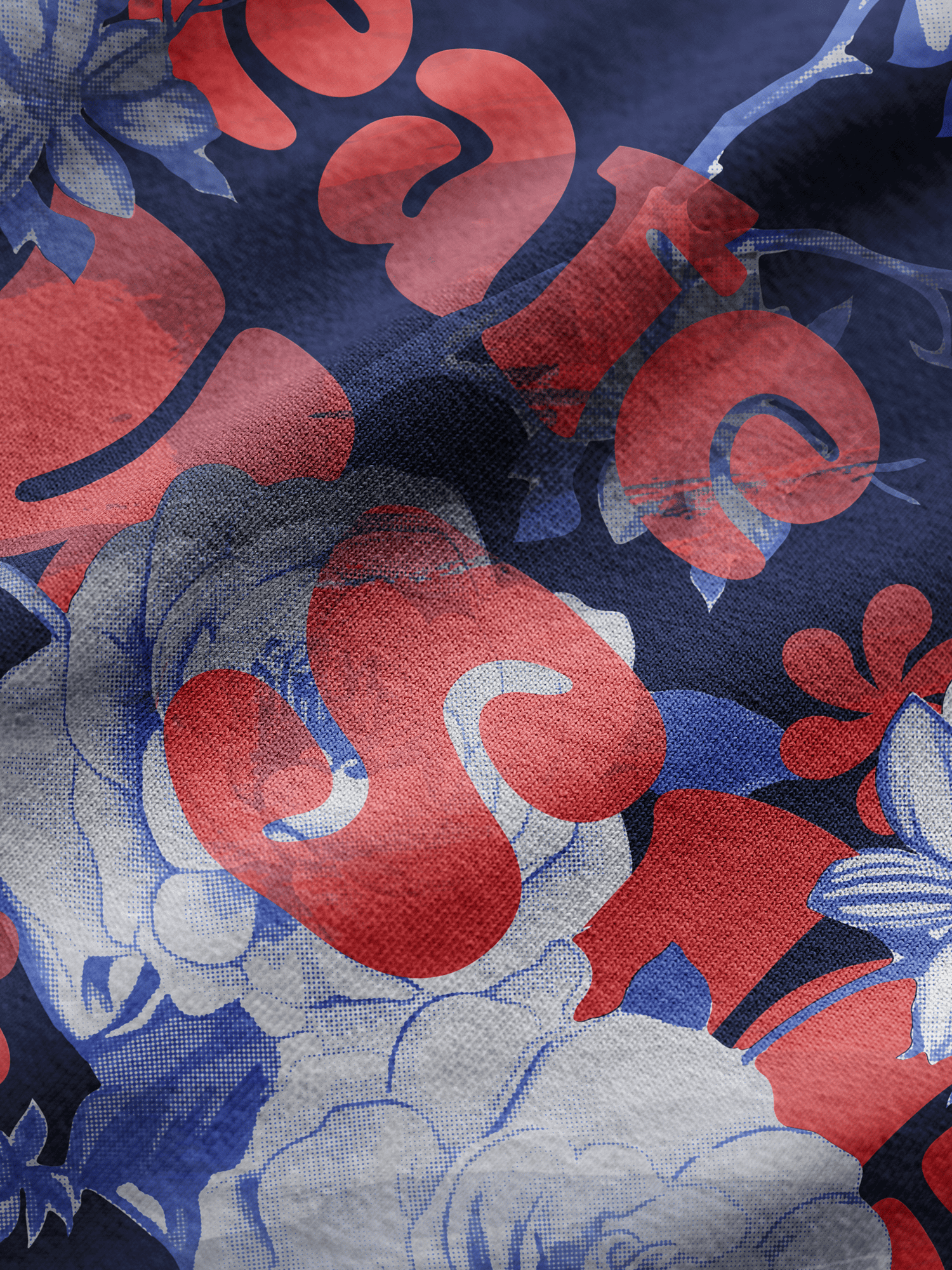 Close-up of fabric with red, blue, and gray floral pattern on a dark background