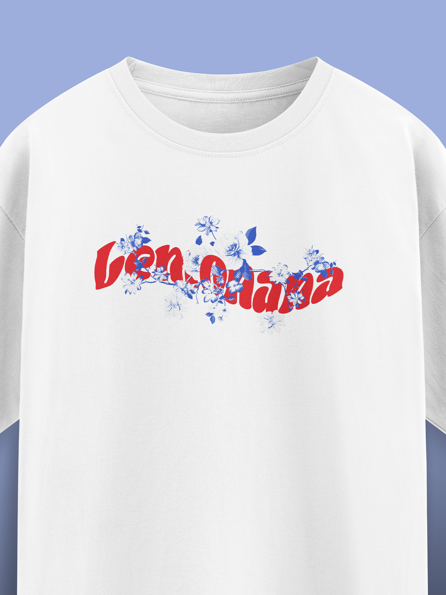 White t-shirt with colorful text and floral design on a blue background