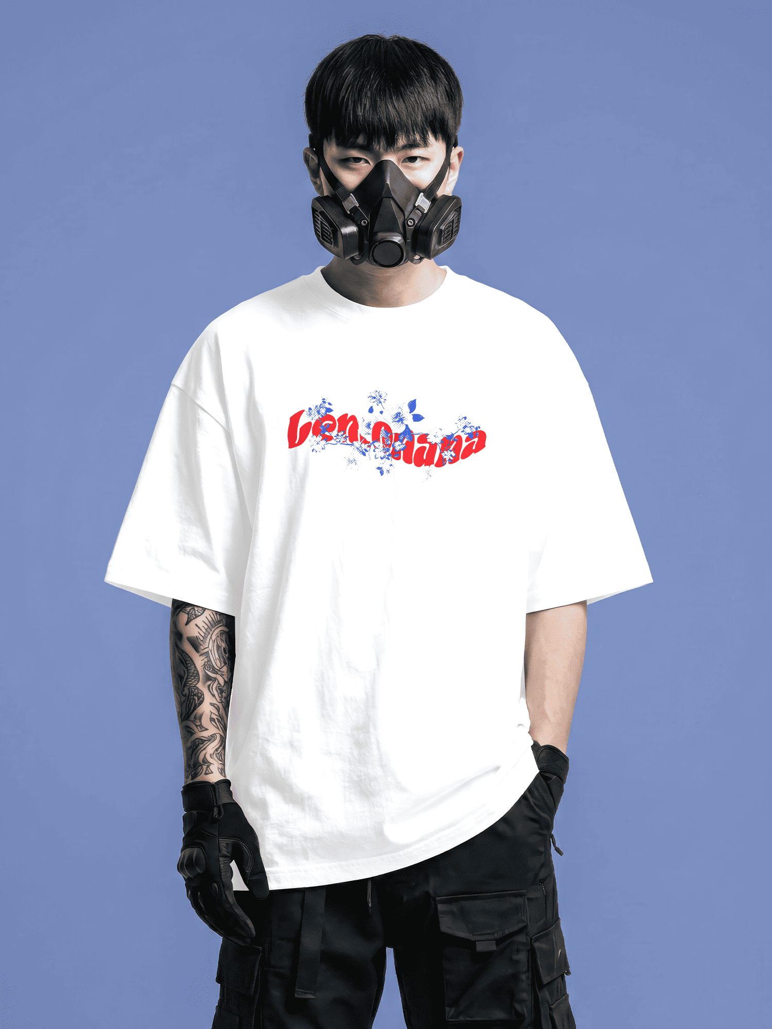 Person wearing a white t-shirt with text and a black mask against a blue background
