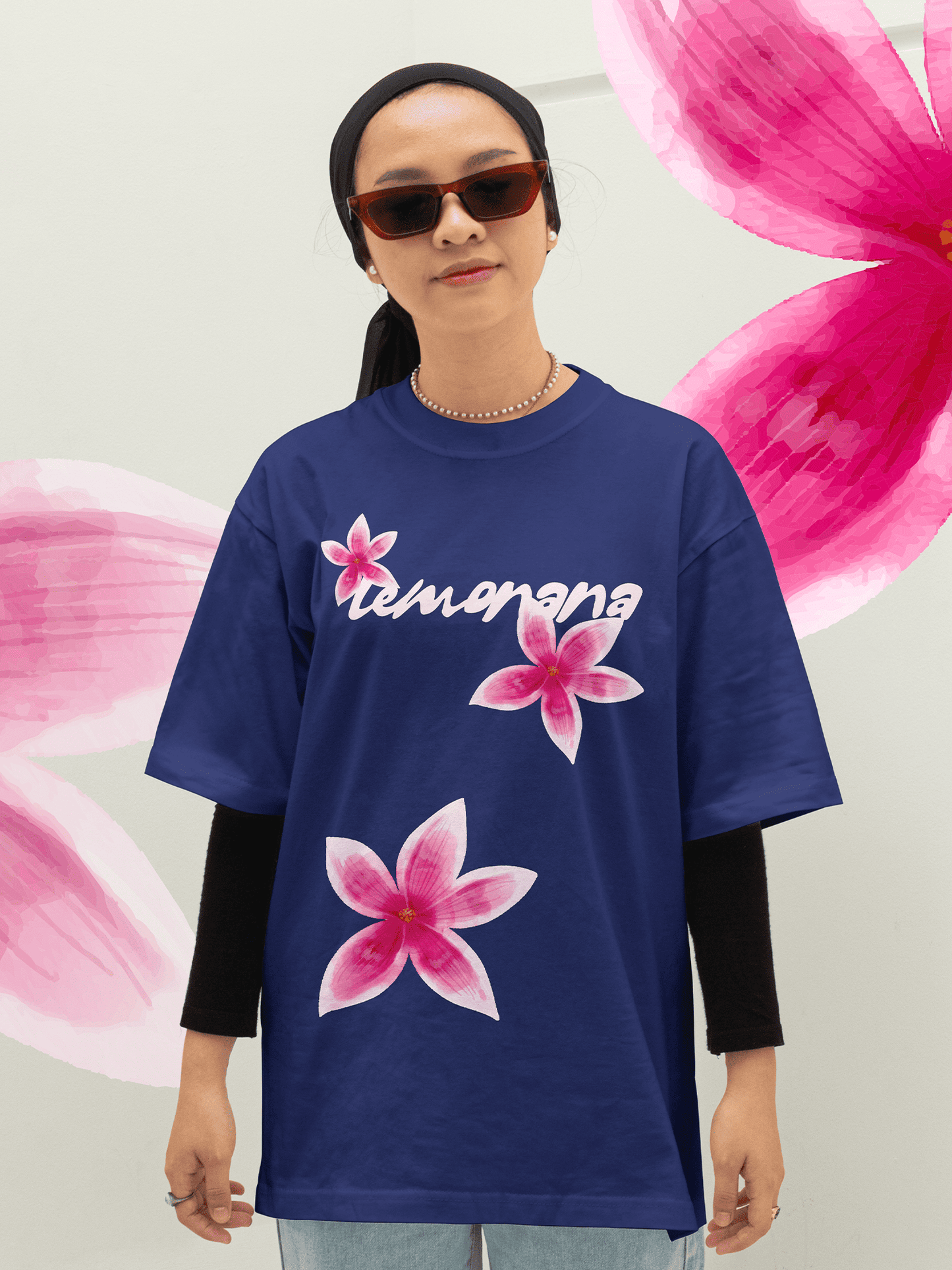 Person wearing a blue t-shirt with pink floral designs and 'Lemonana' text against a floral background