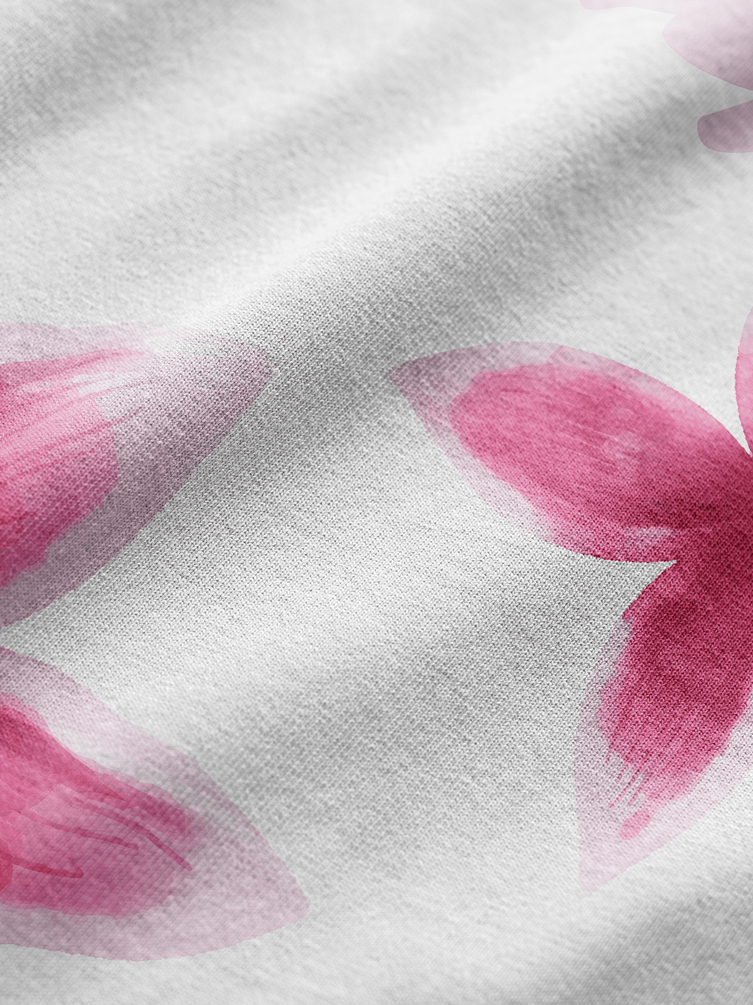 Close-up of pink floral pattern on a white fabric background