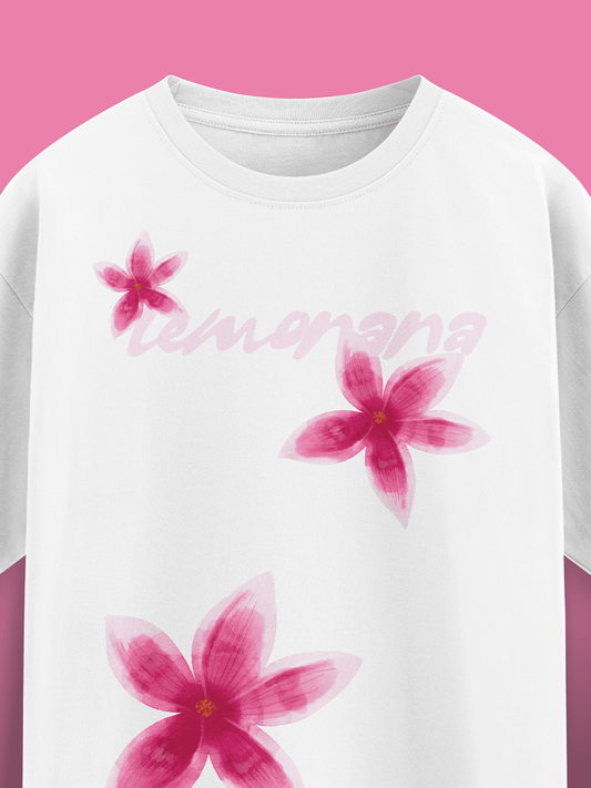 White t-shirt with pink floral designs and 'Lemonana' text on a pink background