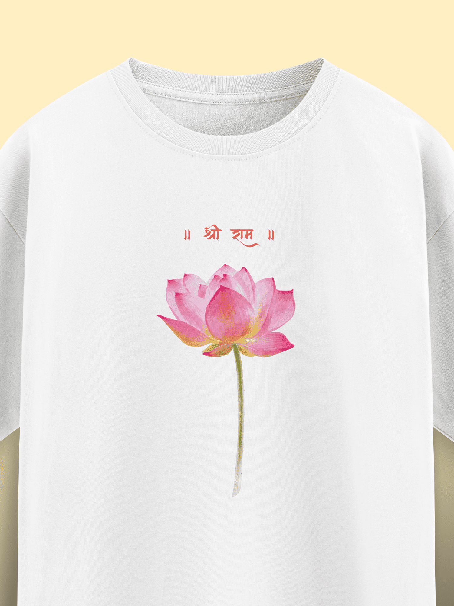 White t-shirt with a pink lotus flower design and red text on a yellow background