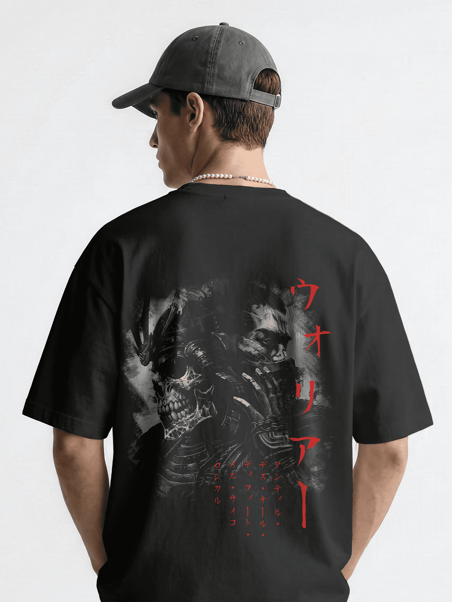 Person wearing a black t-shirt with a graphic design and text on the back, standing against a white background.