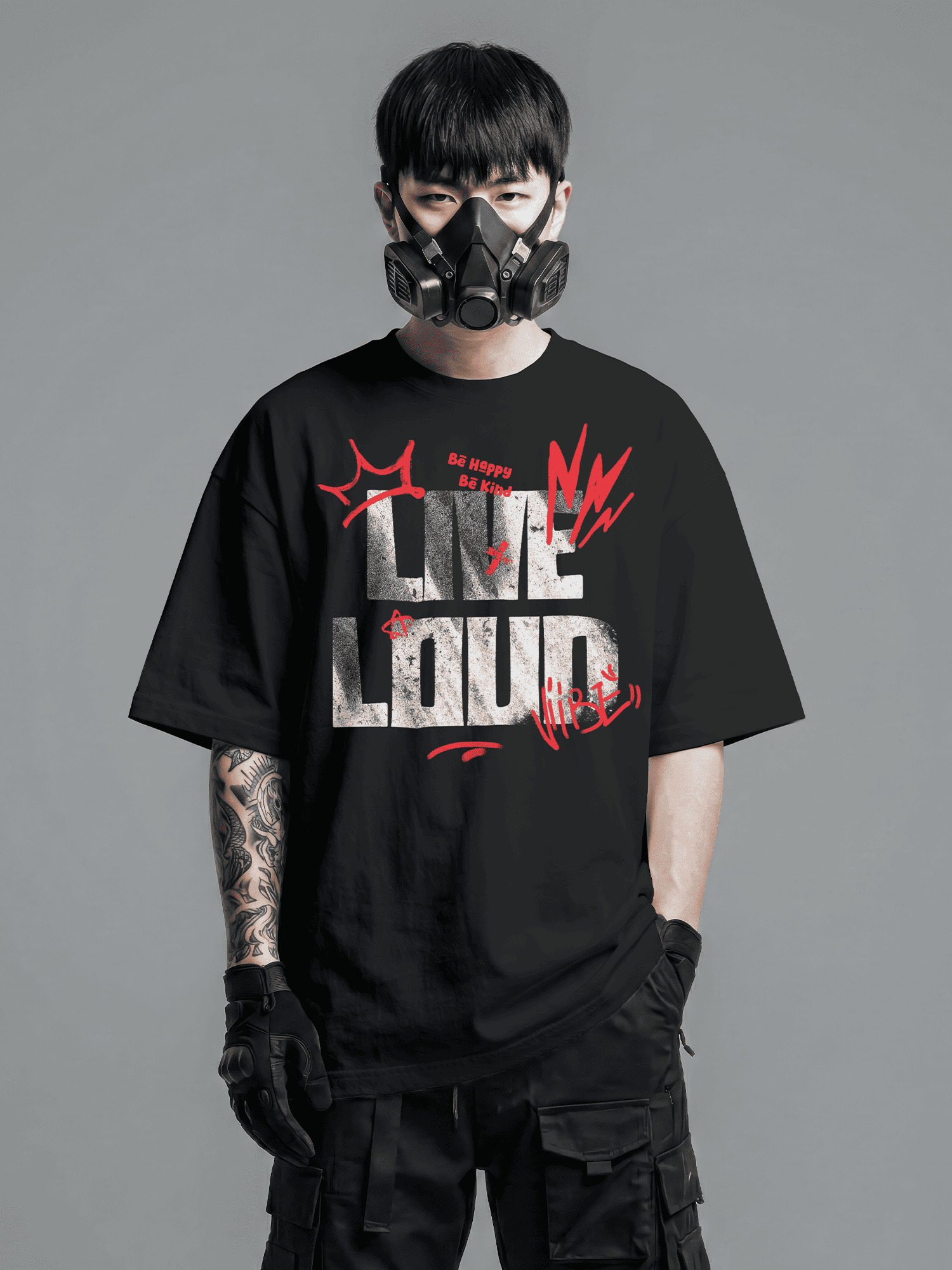 Person wearing a black t-shirt with red and white text and graphics, standing against a gray background.